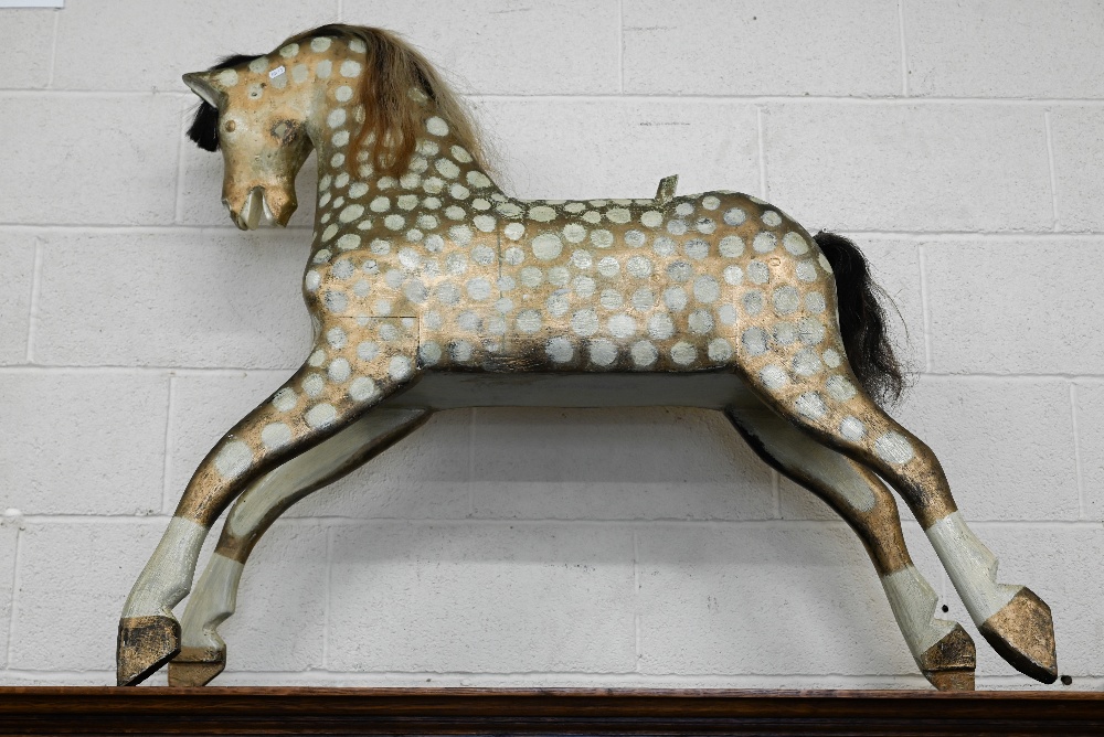 A gilt and cream painted wooden rocking horse (lacks rockers)