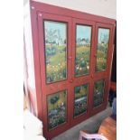 A large pine storage cupboard, the panelled front painted with folk art rural scenes, with shelved