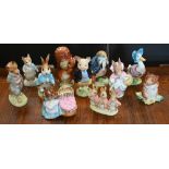 Eleven Beatrix Potter figures and groups with gold/silver back stamps