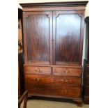 A 19th century mahogany linen press, the top section with panelled doors enclosing four slides on