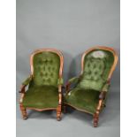 Two Victorian button backed salon armchairs, in green dralon with serpentine seats, raised on turned