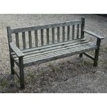 A weathered slatted teak three-seater garden bench, 160 cm wide
