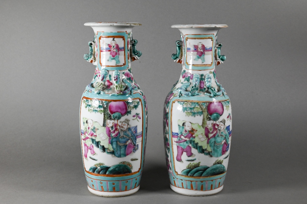 A pair of 19th century Chinese Canton famille rose vases of baluster form with everted foliate rims,
