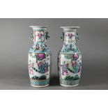 A pair of 19th century Chinese Canton famille rose vases of baluster form with everted foliate rims,