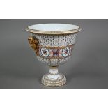 A Paris porcelain urn with campana bowl on stemmed foot, the twin handles as gilt masks of