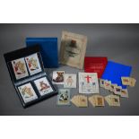 A collection of Kensitas cigarette silks, to/w an album of vintage teddy bear-themed postcards,