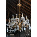 A good French gilt metal and crystal glass adorned ten branch electrolier, suspended from a