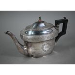 A Regency silver teapot of oval form with foliate engraved decoration and composite handle,