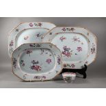 A graduated set of three 18th century Chinese famille rose octagonal platters with lobed corners and