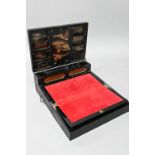 An early 20th century Japanese black lacquered brass mounted writing box with twin hinged top and