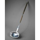Georgian silver punch ladle with oval bowl and stem, the twisted whalebone handle with silver