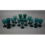 A set of eight 19th century green wine glasses with conical bowls, baluster stems and ground-out
