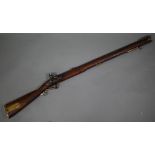 A Georgian flintlock 'Brown Bess' musket, the 78.5 cm barrel with bayonet mounting-clip, on walnut