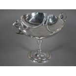 An Edwardian silver comport in the Arts and Crafts manner, with twin scroll handles and part-