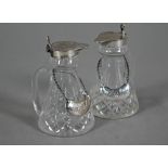 A pair of cut glass conical whisky noggins with silver tops and engraved labels, S. Blackensee &