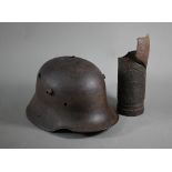 A WWI German helmet 'Delville Wood' to/with a Somme shell fragment - both heavily degraded