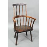 An 18th century oak/elm low spindle back Windsor armchair, West Country, raised on stick legs