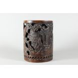 A Chinese double-walled cylindrical bronze brush pot, bitong, cast in relief with pagodas and