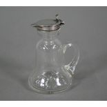 A glass whisky noggin of bell-form with drawn handle and star-cut base, hinged silver top by Hukin &