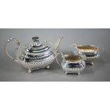 A heavy quality Edwardian Regency Revival three-piece tea service of oblong half-reeded and