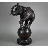 A cast patinated dark bronze sculpture after A Barye, a trumpeting elephant raised on a globe - on a