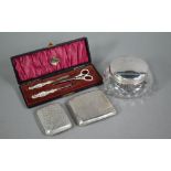 Two engraved silver cigarette cases, Birmingham 1911/17, to/w a cut glass powder bowl with silver