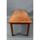 An antique French cherry wood farmhouse table, the plank top with cleated ends and a draw leaf