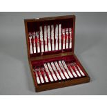 An antique set of twelve electroplated dessert knives and forks with engraved blades and mother of