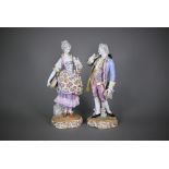 A pair of late 19th century German porcelain figures of an elegant 18th century couple, underglaze