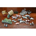 A quantity of Britains die-cast farm animals and other figures, fencing, hay-rick, wagon etc - all