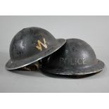 A WWII Police helmet, the original painted finish stencilled 'POLICE' c/with liner and chin strap