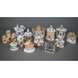 Seven 19th century pottery cottage pastille-burners, to/w five similar ornaments and another dated