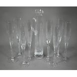 A set of seven Thomas Goode large glass champagne flutes, 40 cm high, to/w a similar tall and