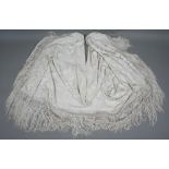 A circa 1930s cream silk 'piano' shawl with floral decoration and long fringe, approx 180 cm