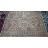 A contemporary Indian Agra carpet, the yelllow/ochre ground with muted floral design, 204 cm x 154