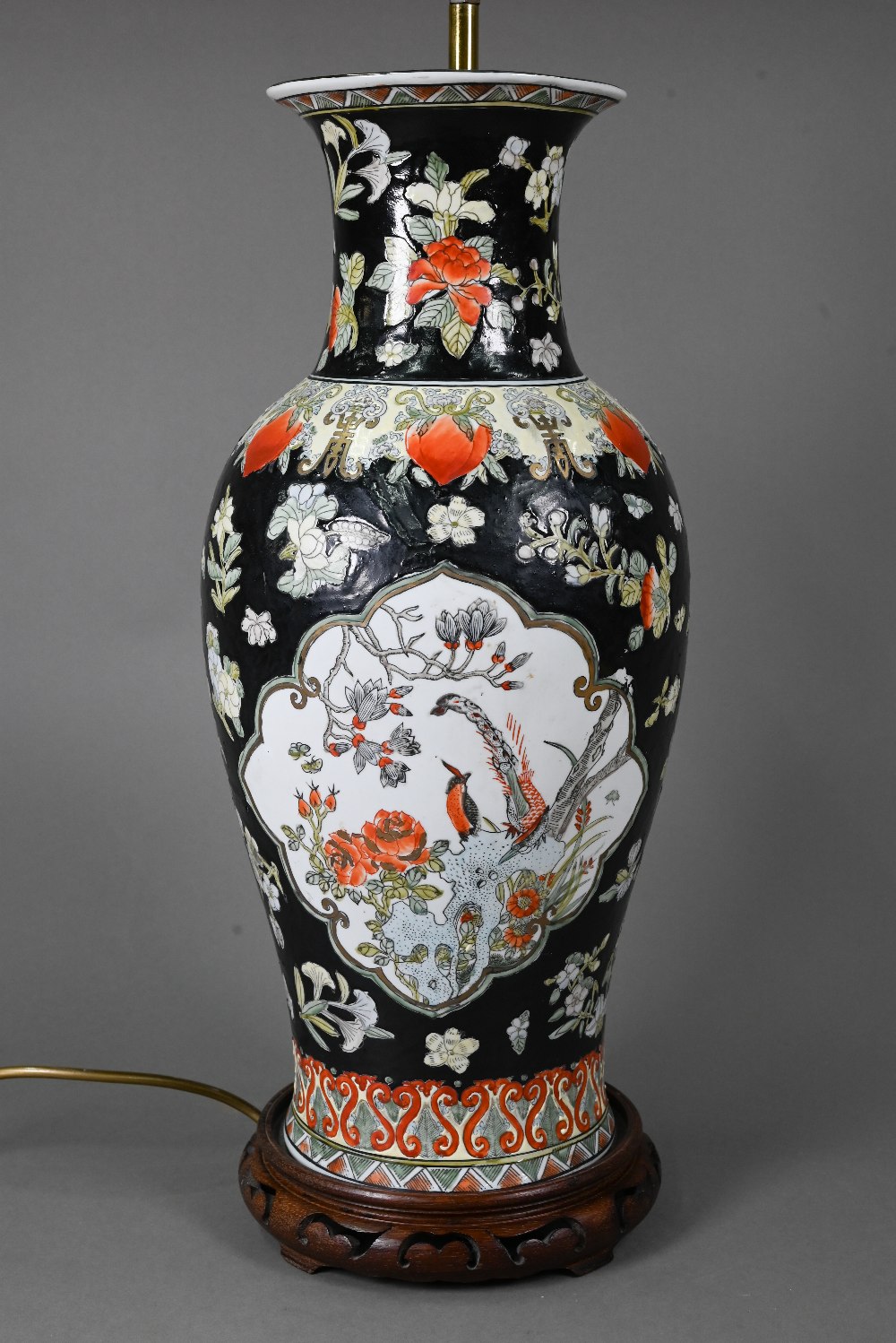 A late 19th or early 20th century Chinese famille noire style baluster vase (drilled and mounted
