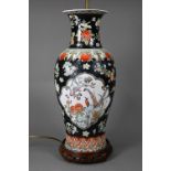 A late 19th or early 20th century Chinese famille noire style baluster vase (drilled and mounted