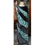 A 1920s beaded and sequin evening dress in black, white and aqua striped panels