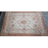 A traditional Savonnerie needlepoint rug, pale camel ground, 266 cm x 173 cm