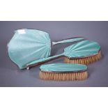 A silver and green basse-taille enamel three-piece brush set with hand-mirror, Mappin & Webb,