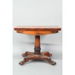 A Victorian rosewood card table, the fold over top enclosing a circular green baize surface,
