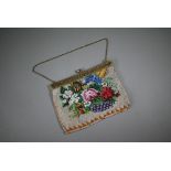 A glass beadwork bag decorated with flowers, circa 1900, on gilt metal folding clasp fitting, and