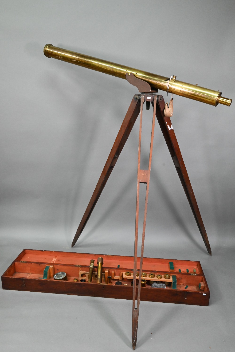 Dolland, London, a late 19th century brass tube telescope, raised on a folding wooden tripod stand -