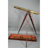 Dolland, London, a late 19th century brass tube telescope, raised on a folding wooden tripod stand -