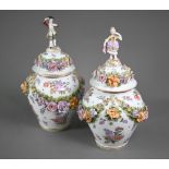 A good pair of German porcelain vases, the domed covers surmounted by an 18th century lady and