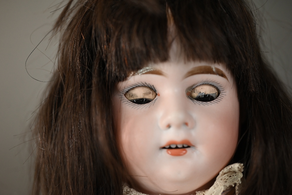 An Armand Marseille no 3500 AM 2 1/2D bisque-headed girl doll with brown wig, closing brown eyes and - Image 7 of 8