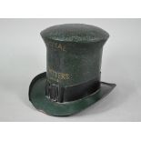 An enamelled tin trader's signed modelled as a top hat, inscribed 'Royal Hatters, London', 22 cm