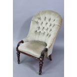 A Victorian deep-buttoned green dralon nursing chair, raised on moulded turned front legs