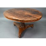 An early Victorian rosewood breakfast table, the circular tilt top raised on a turned support, to