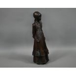 A bronzed pottery sculpture of a young woman, standing, in a long dress, 77 cm h